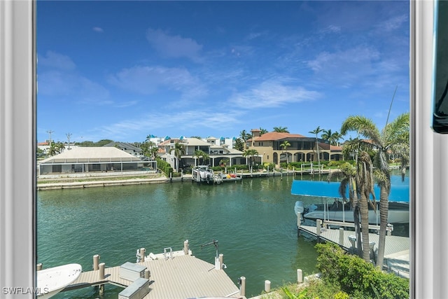 water view with nearby suburban area and a dock