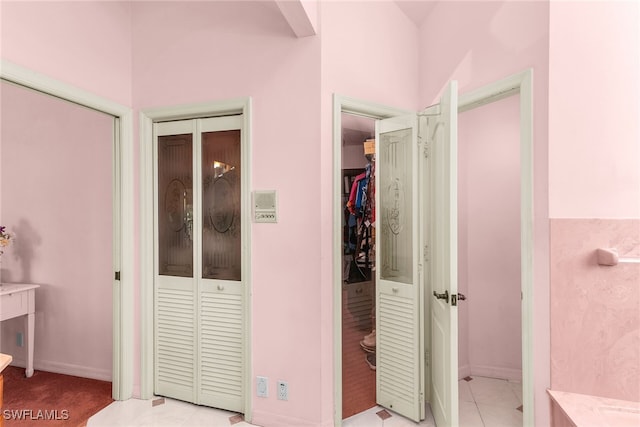 bedroom featuring baseboards and two closets
