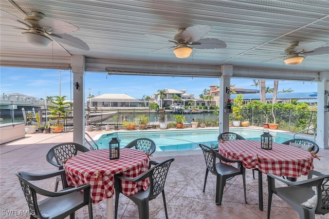 view of patio featuring ceiling fan, outdoor dining area, an outdoor pool, and fence