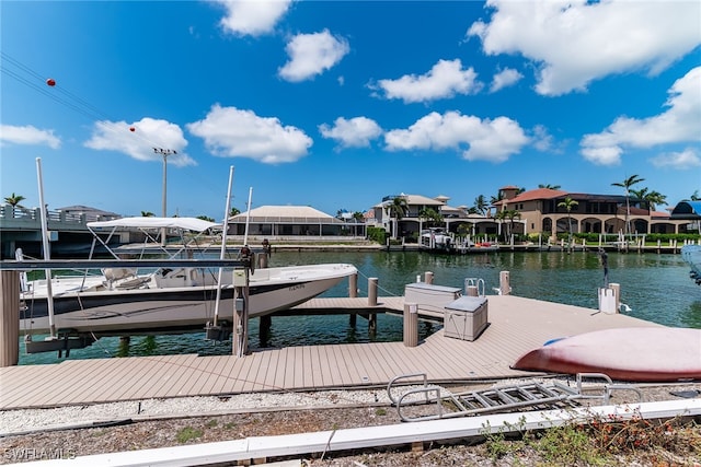 dock area with boat lift and a water view