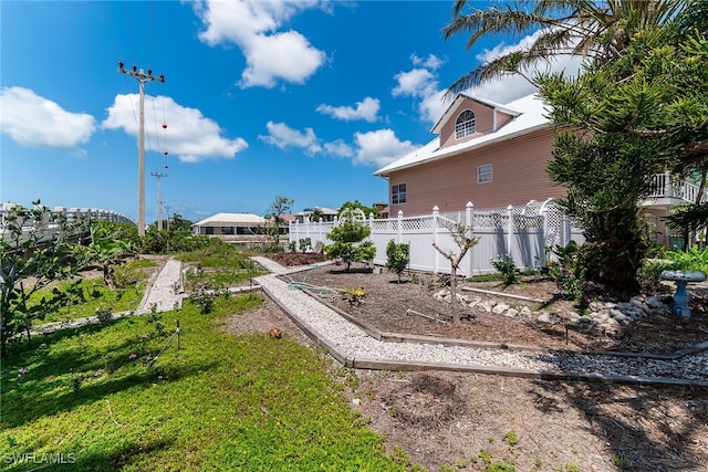 view of yard featuring fence and a vegetable garden