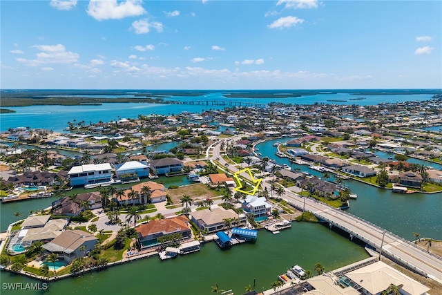 aerial view of residential area featuring a nearby body of water and a notable bridge