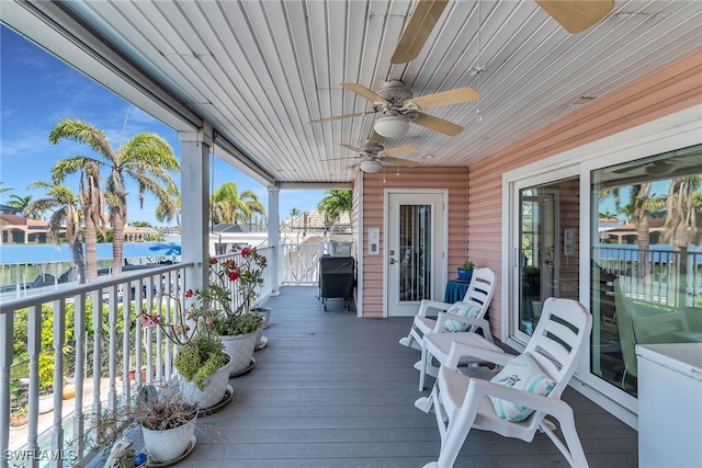 wooden terrace featuring ceiling fan