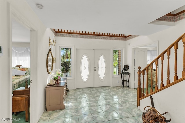 foyer entrance with stairway and french doors