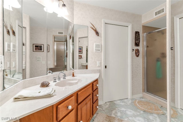 bathroom featuring a shower stall and vanity