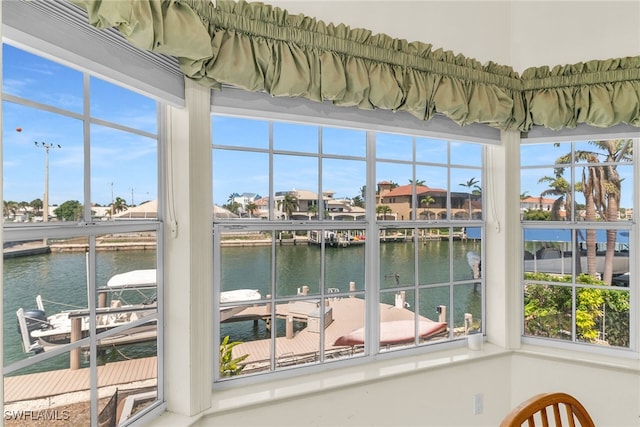 unfurnished sunroom with a water view