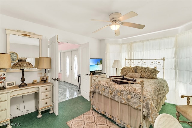 bedroom featuring light colored carpet, light tile patterned floors, and ceiling fan