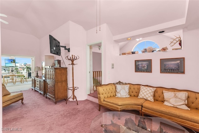 carpeted living room with high vaulted ceiling