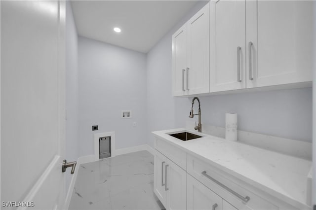 clothes washing area featuring hookup for an electric dryer, cabinet space, hookup for a washing machine, marble finish flooring, and baseboards