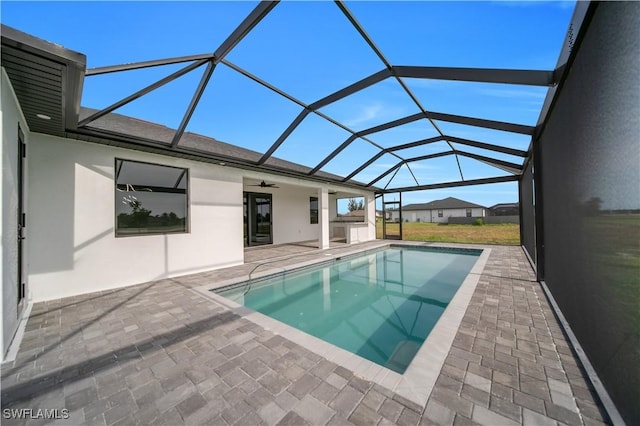 outdoor pool featuring a patio, a ceiling fan, and a lanai