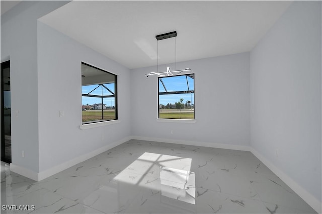 empty room with baseboards and marble finish flooring