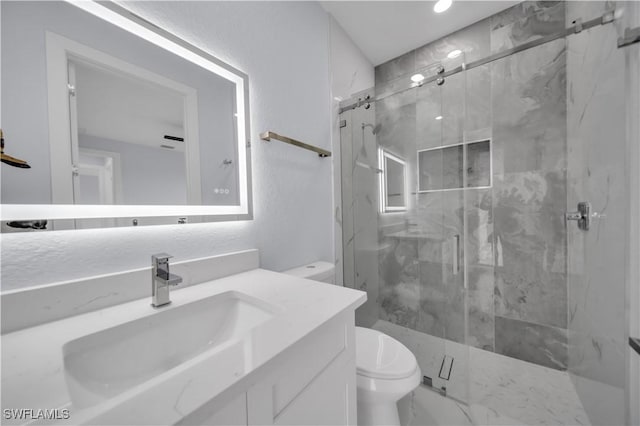 full bathroom featuring toilet, a marble finish shower, vanity, and recessed lighting