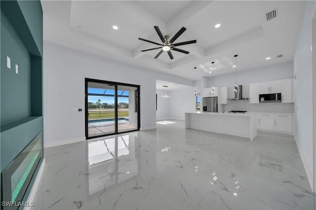 unfurnished living room with coffered ceiling, recessed lighting, a ceiling fan, light marble finish floors, and baseboards