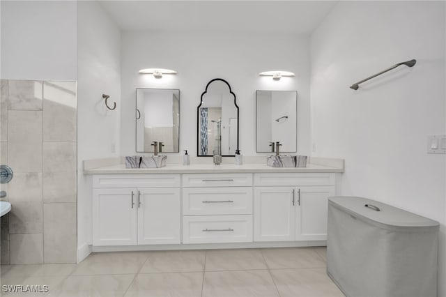 bathroom with double vanity and tile patterned flooring