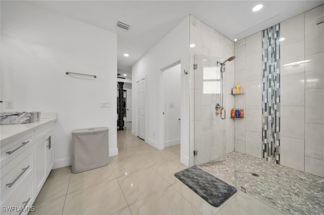 bathroom with a walk in shower, recessed lighting, tile patterned flooring, baseboards, and vanity