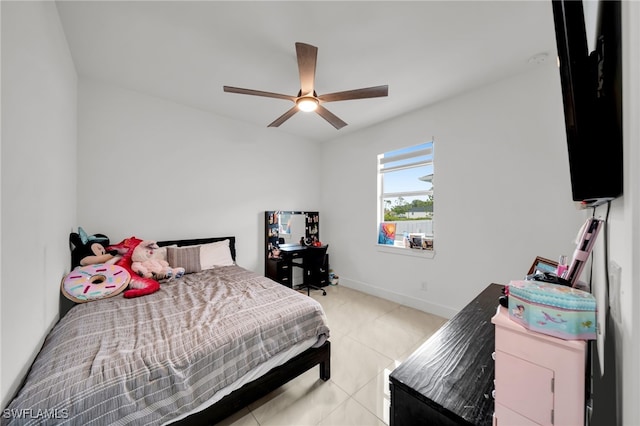 bedroom featuring light tile patterned floors, baseboards, and a ceiling fan