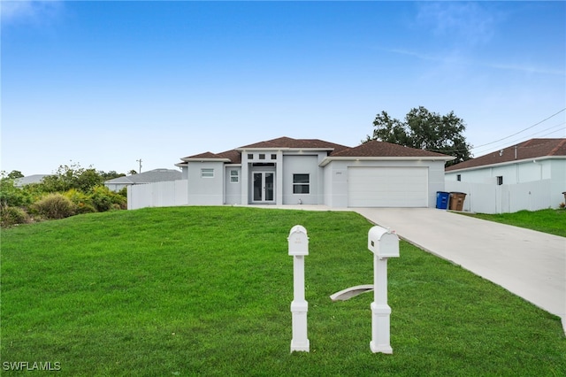 prairie-style house with driveway, stucco siding, and an attached garage