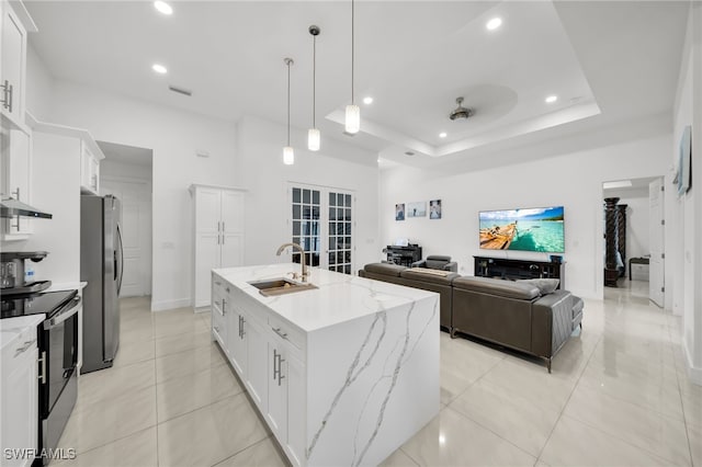 kitchen with appliances with stainless steel finishes, a sink, recessed lighting, french doors, and white cabinetry