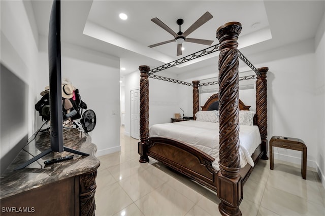 bedroom with baseboards, a tray ceiling, recessed lighting, and ceiling fan