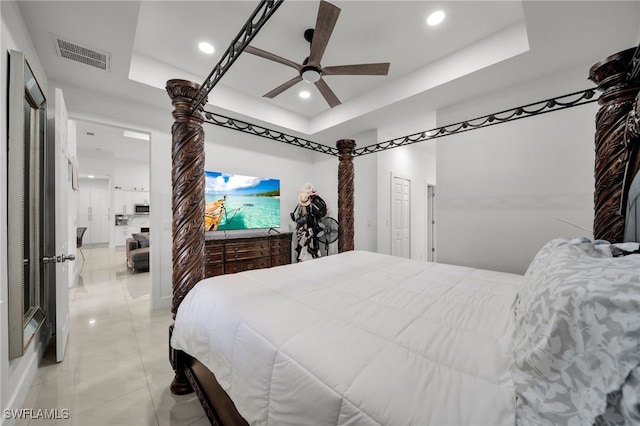 bedroom with a raised ceiling, recessed lighting, and a ceiling fan