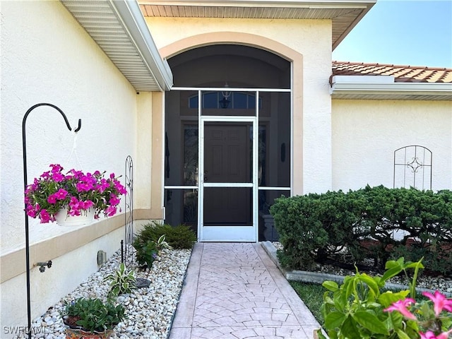 view of exterior entry with stucco siding
