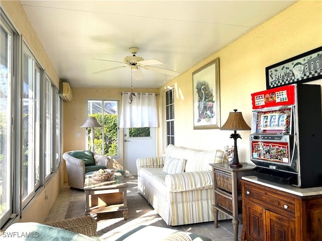 living area with a wall mounted AC and ceiling fan