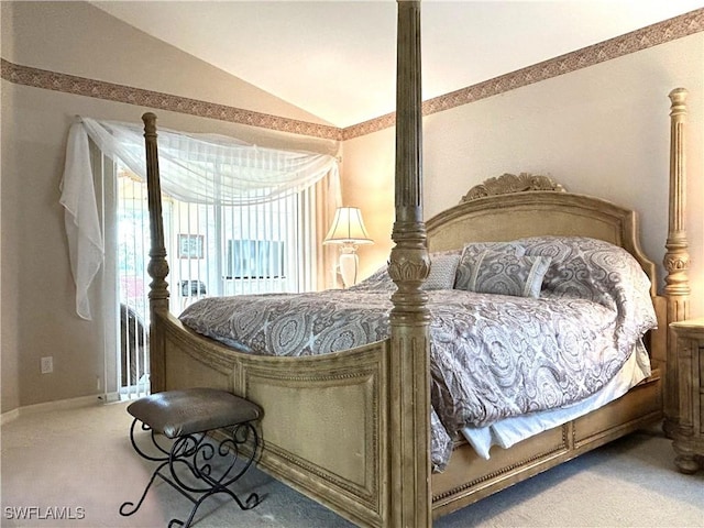 carpeted bedroom featuring vaulted ceiling and baseboards