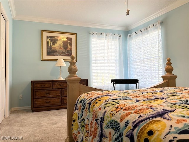 bedroom featuring carpet floors, ornamental molding, and baseboards