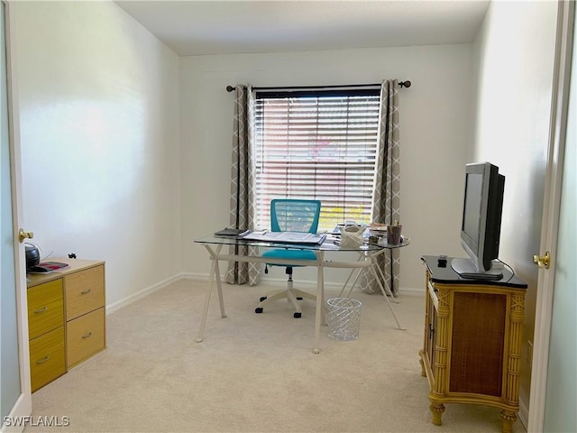 office area featuring light colored carpet and baseboards