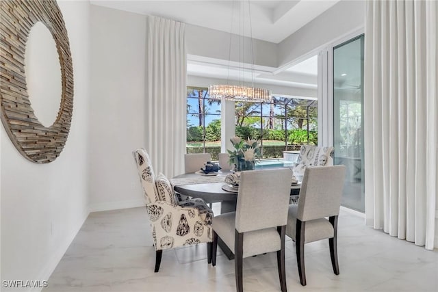 14179 Charthouse Ct, Naples, FL 34114 - dining room featuring a chandelier and baseboards