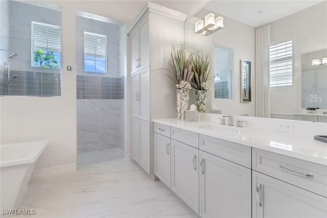 14179 Charthouse Ct, Naples, FL 34114 - bathroom featuring walk in shower, vanity, a freestanding tub, and marble look tiles