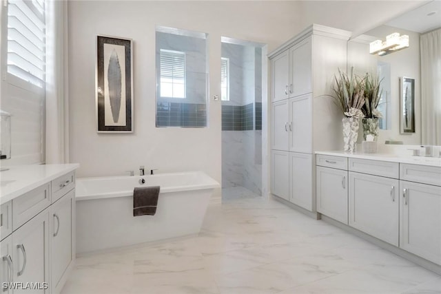 14179 Charthouse Ct, Naples, FL 34114 - bathroom with marble finish floors, a freestanding tub, two vanities, and walk in shower
