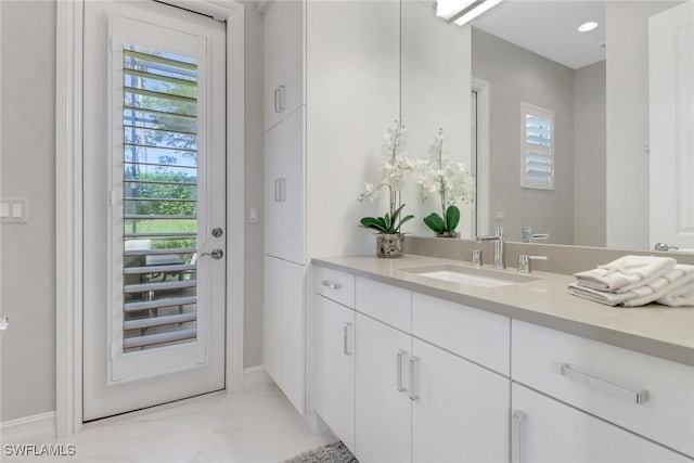 14179 Charthouse Ct, Naples, FL 34114 - bathroom featuring vanity, healthy amount of natural light, and baseboards