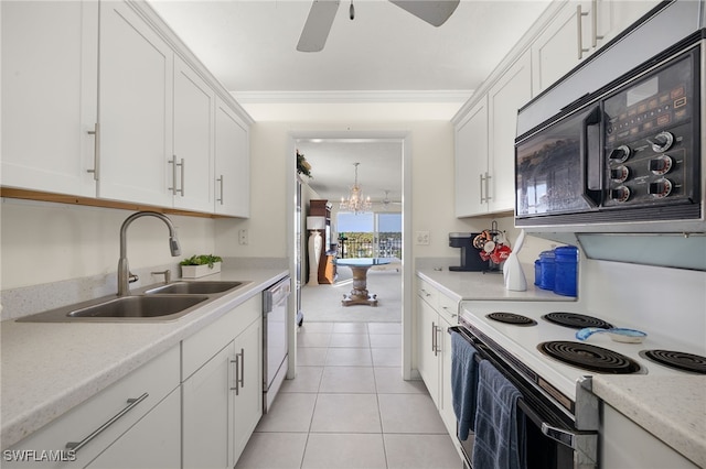 2150 Gulf Shore Blvd N Unit 701, Naples, FL 34103 - kitchen with black microwave, a sink, white cabinets, white electric range oven, and light countertops