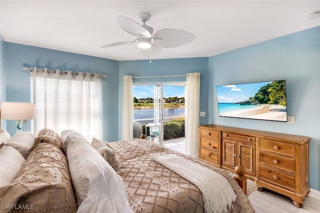 bedroom with access to exterior, wood finished floors, and a ceiling fan