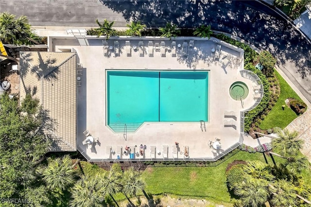 view of subject property with a pool