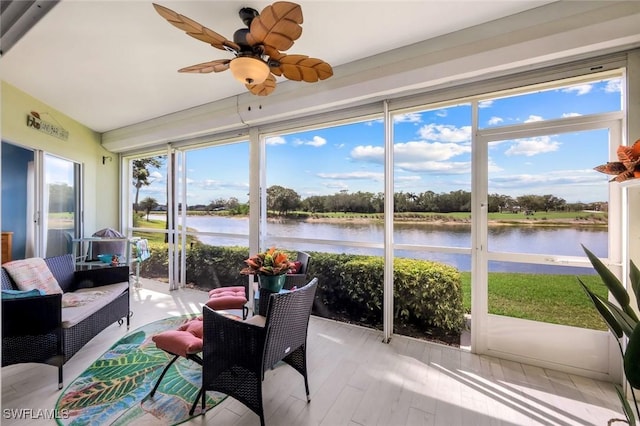 sunroom / solarium with a water view, ceiling fan, and an outdoor hangout area