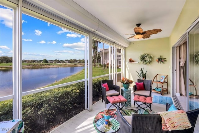sunroom featuring a water view and ceiling fan