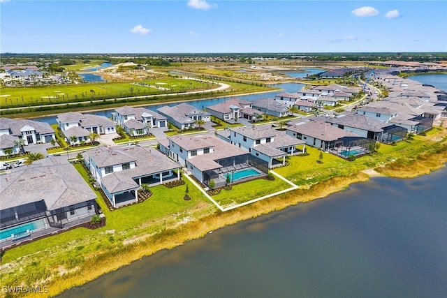 aerial view of residential area featuring a large body of water