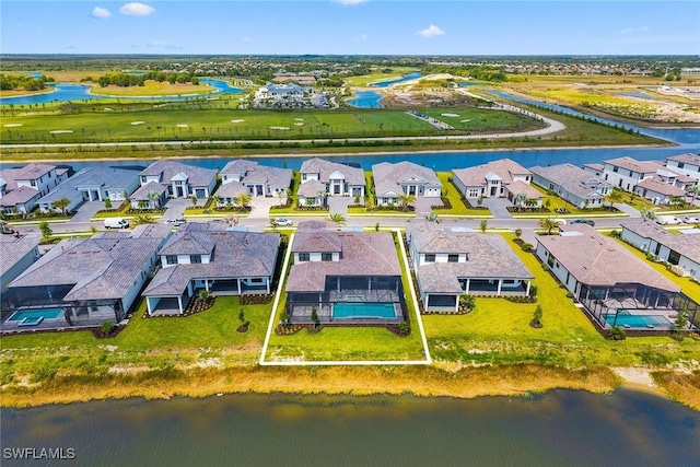 aerial view of residential area with a large body of water and property boundaries highlighted