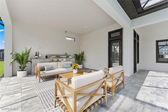 view of patio featuring area for grilling, exterior kitchen, and outdoor lounge area