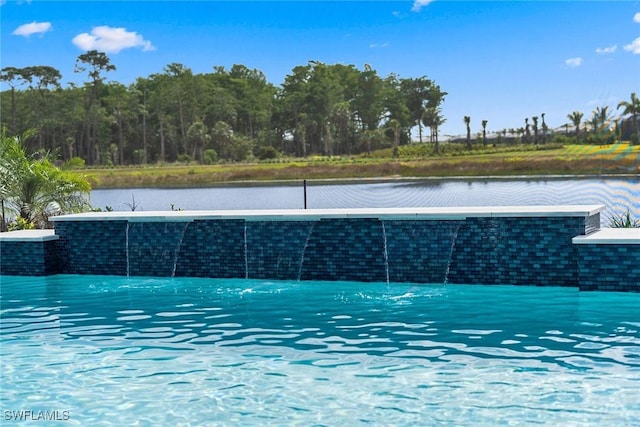 view of swimming pool with a water view