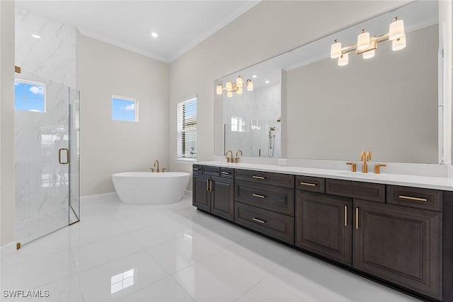 full bath with a marble finish shower, a soaking tub, double vanity, ornamental molding, and tile patterned flooring