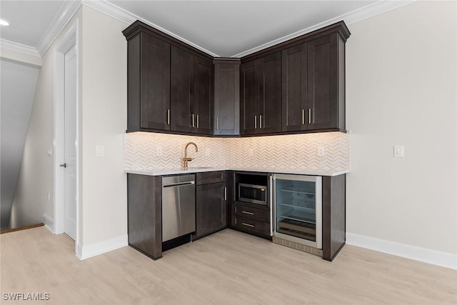 bar featuring wine cooler, light wood finished floors, appliances with stainless steel finishes, tasteful backsplash, and ornamental molding