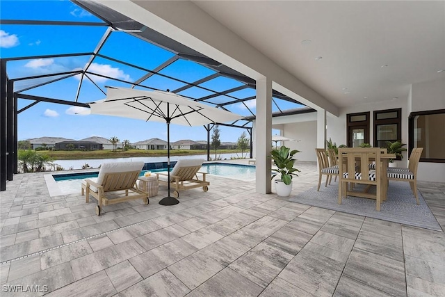 view of patio / terrace with an outdoor pool, a lanai, and outdoor dining space