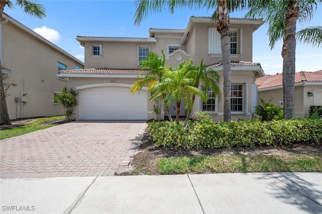 10310 Carolina Willow Dr, Fort Myers, FL 33913 - mediterranean / spanish-style house with a tile roof, stucco siding, decorative driveway, and a garage
