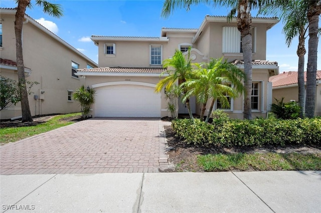 10310 Carolina Willow Dr, Fort Myers, FL 33913 - mediterranean / spanish home with a tiled roof, stucco siding, and decorative driveway