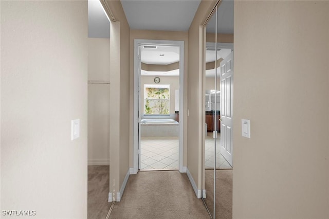 10310 Carolina Willow Dr, Fort Myers, FL 33913 - hall featuring carpet, baseboards, and tile patterned flooring