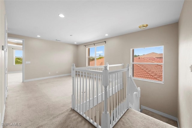 10310 Carolina Willow Dr, Fort Myers, FL 33913 - hall with an upstairs landing, healthy amount of natural light, carpet floors, baseboards, and recessed lighting