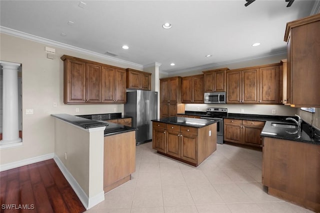 10310 Carolina Willow Dr, Fort Myers, FL 33913 - kitchen with appliances with stainless steel finishes, decorative columns, crown molding, a peninsula, and baseboards